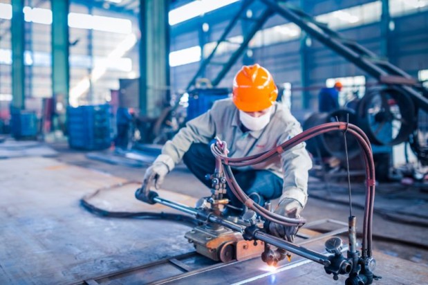 Worker doing electric welding,factory manufacturing